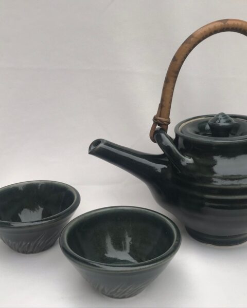 Green teapot with cane handle and cups
