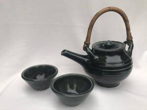 Green teapot with cane handle and cups